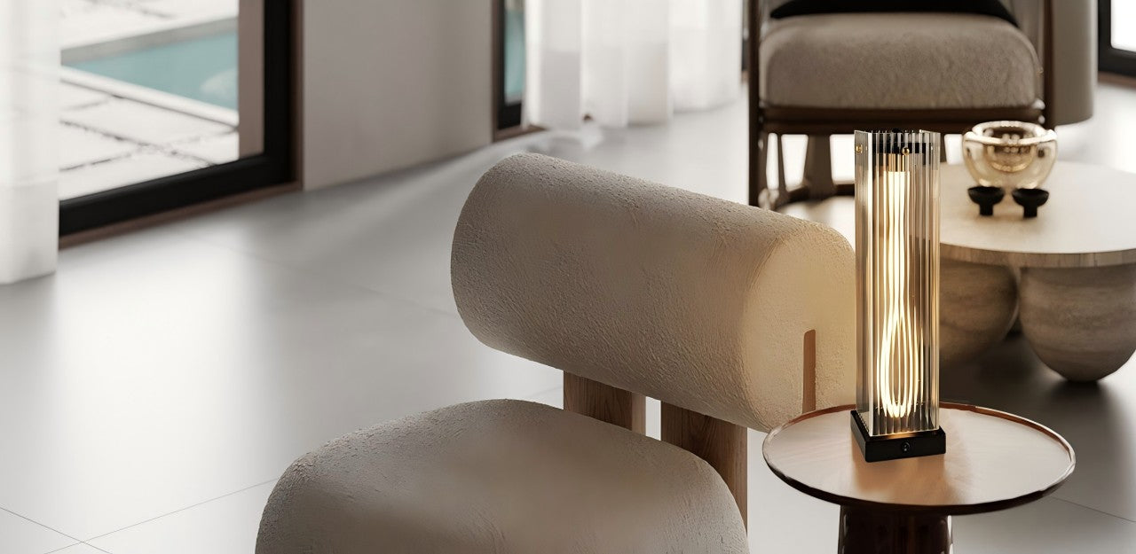 Even in a small corner, the table lamp can add ambiance. The transparent ribbed glass lampshade, along with the vertical light stripe inside, creates a soft, layered light that adds a touch of warmth and elegance.